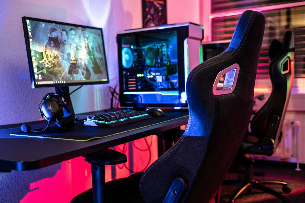 Gaming chair at a desk with gaming desktop PC rig and lots of RGB colors