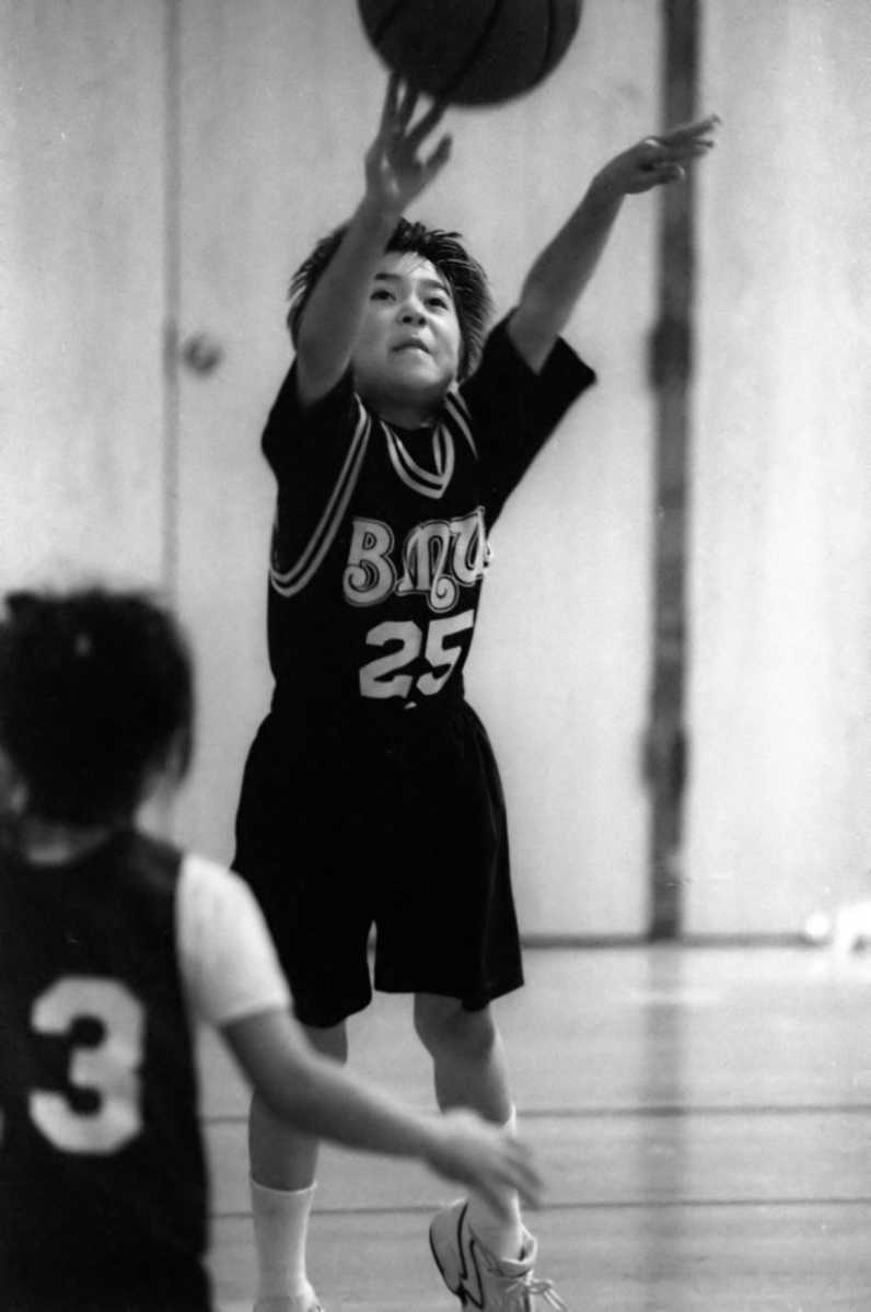 Child basketball league shooting a basketball